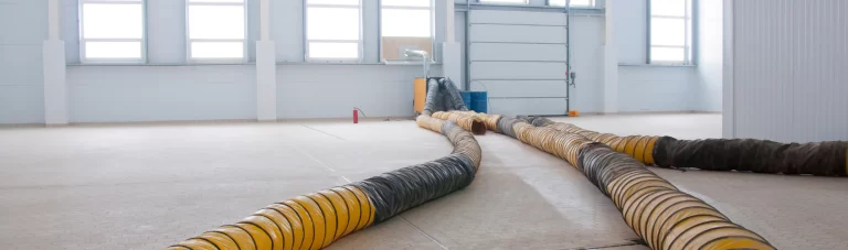 Yellow ducting hose laying on floor